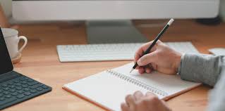 Student writing at a desk